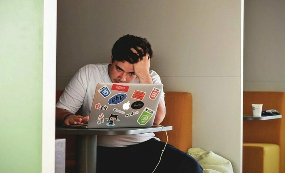 Frustrated and stressed student on laptop applying for jobs